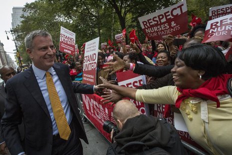 Democratic New York City mayoral candidate Bill de Blasio (L) is greeted by supporters during the New York State Nurses Association rally ou Democratic New York City mayoral candidate Bill de Blasio (L) is greeted by supporters during the New York State Nurses Association rally ou
