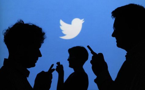 People holding mobile phones are silhouetted against a backdrop projected with the Twitter logo in this illustration picture taken in Warsaw People holding mobile phones are silhouetted against a backdrop projected with the Twitter logo in this illustration picture taken in Warsaw