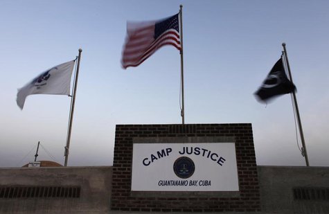 Flags wave above the sign posted at the entrance to Camp Justice, the site of the U.S. war crimes tribunal compound, at Guantanamo Bay U.S. Flags wave above the sign posted at the entrance to Camp Justice, the site of the U.S. war crimes tribunal compound, at Guantanamo Bay U.S.