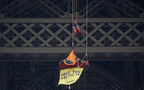 A French firefighter (top) approaches a Greenpeace activist hanging from the second floor of the Eiffel Tower in Paris, October 26, 2013. RE A French firefighter (top) approaches a Greenpeace activist hanging from the second floor of the Eiffel Tower in Paris, October 26, 2013. RE