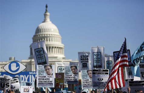 Demonstrators hold up their signs during the "Stop Watching Us: A Rally Against Mass Surveillance" march near the U.S. Capitol in Washington Demonstrators hold up their signs during the "Stop Watching Us: A Rally Against Mass Surveillance" march near the U.S. Capitol in Washington