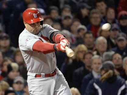 St. Louis Cardinals right fielder Carlos Beltran hits a RBI single against the Boston Red Sox in the 7th inning during game two of the MLB b St. Louis Cardinals right fielder Carlos Beltran hits a RBI single against the Boston Red Sox in the 7th inning during game two of the MLB b