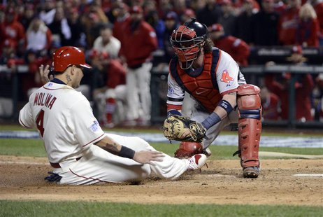 Oct 26, 2013; St. Louis, MO, USA; St. Louis Cardinals catcher Yadier Molina (4) is tagged out by Boston Red Sox catcher Jarrod Saltalamacchi Oct 26, 2013; St. Louis, MO, USA; St. Louis Cardinals catcher Yadier Molina (4) is tagged out by Boston Red Sox catcher Jarrod Saltalamacchi