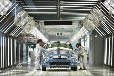 Employees work at the third factory of Dongfeng Peugeot Citroen Automobile company, after its inauguration ceremony, in Wuhan, July 2, 2013. Employees work at the third factory of Dongfeng Peugeot Citroen Automobile company, after its inauguration ceremony, in Wuhan, July 2, 2013.