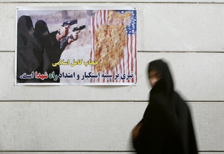 An Iranian woman walks past an anti-U.S. poster during a visit to a war museum in the city of Khorramshahr, 1350 km (844 miles) southwest of An Iranian woman walks past an anti-U.S. poster during a visit to a war museum in the city of Khorramshahr, 1350 km (844 miles) southwest of