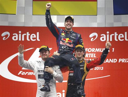 Mercedes Formula One driver Nico Rosberg of Germany (L) and Lotus F1 Formula One driver Romain Grosjean of France (R) lift Red Bull Formula Mercedes Formula One driver Nico Rosberg of Germany (L) and Lotus F1 Formula One driver Romain Grosjean of France (R) lift Red Bull Formula