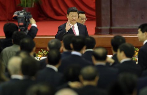 China's President Xi Jinping waves as he and Premier Li Keqiang (behind) arrive for a reception marking the 64th anniversary of the founding China's President Xi Jinping waves as he and Premier Li Keqiang (behind) arrive for a reception marking the 64th anniversary of the founding