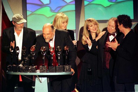 Members of the band Fleetwod Mac appear at the podium after being inducted into the Rock and Roll Hall of Fame at the Rock and Roll Hall of Members of the band Fleetwod Mac appear at the podium after being inducted into the Rock and Roll Hall of Fame at the Rock and Roll Hall of
