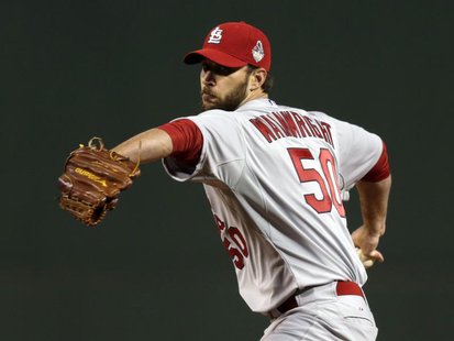 St. Louis Cardinals starting pitcher Adam Wainwright throws a pitch against the Boston Red Sox in the first inning during game one of the ML St. Louis Cardinals starting pitcher Adam Wainwright throws a pitch against the Boston Red Sox in the first inning during game one of the ML