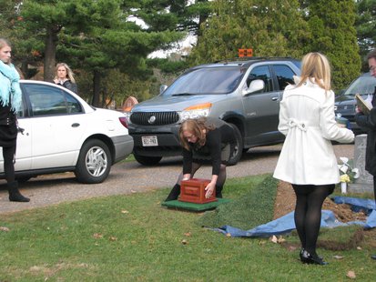Marcie Steger places her daugher Kira Steger's ashes alongside the grave, which is next to her great-great grandparents Marcie Steger places her daugher Kira Steger's ashes alongside the grave, which is next to her great-great grandparents