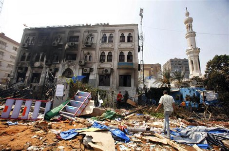 A man walks on debris outside the Rabaa Adawiya mosque complex, after the clearing of a protest camp around the mosque, in Cairo, in this fi A man walks on debris outside the Rabaa Adawiya mosque complex, after the clearing of a protest camp around the mosque, in Cairo, in this fi