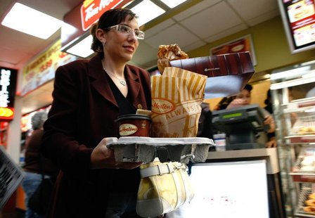 A customer exits a new Tim Hortons coffee and bake shop in New York's Penn Station July 13, 2009. REUTERS/Brendan McDermid A customer exits a new Tim Hortons coffee and bake shop in New York's Penn Station July 13, 2009. REUTERS/Brendan McDermid