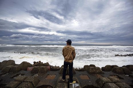 A man watches waves break into anti-tsunami barriers after a storm in Iwaki, Fukushima Prefecture September 16, 2013. REUTERS/Stringer A man watches waves break into anti-tsunami barriers after a storm in Iwaki, Fukushima Prefecture September 16, 2013. REUTERS/Stringer