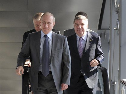 Russia's President Vladimir Putin (L) and International Olympic Committee (IOC) President Thomas Bach (R) walk during the opening of a railw Russia's President Vladimir Putin (L) and International Olympic Committee (IOC) President Thomas Bach (R) walk during the opening of a railw