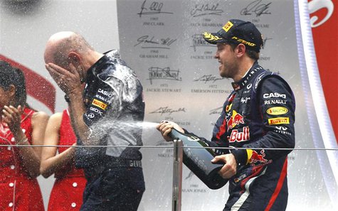 Red Bull Formula One driver Sebastian Vettel of Germany (R) sprays Red Bull technical chief Adrian Newey after the Indian F1 Grand Prix at t Red Bull Formula One driver Sebastian Vettel of Germany (R) sprays Red Bull technical chief Adrian Newey after the Indian F1 Grand Prix at t