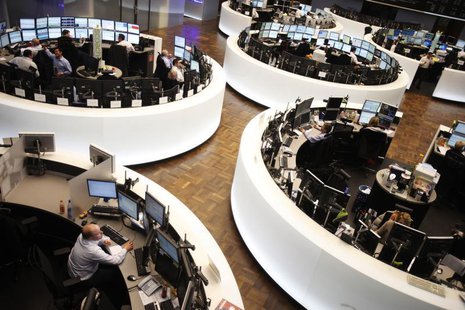 Traders work at their desks at the Frankfurt stock exchange February 1, 2012. REUTERS/Alex Domanski Traders work at their desks at the Frankfurt stock exchange February 1, 2012. REUTERS/Alex Domanski