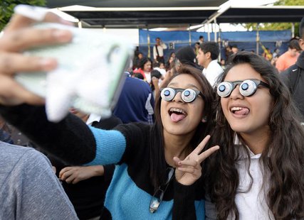 Children take pictures during an attempt to break a world record for largest gathering of people wearing googly eye glasses (also know as sl Children take pictures during an attempt to break a world record for largest gathering of people wearing googly eye glasses (also know as sl