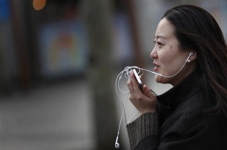 A woman speaks on her smartphone as she walks on a busy street in downtown Shanghai in this March 13, 2013 file photo. REUTERS/Carlos Barria A woman speaks on her smartphone as she walks on a busy street in downtown Shanghai in this March 13, 2013 file photo. REUTERS/Carlos Barria
