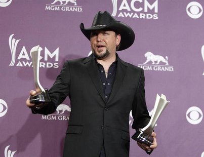 Jason Aldean poses with his awards for male vocalist of the year and vocal event of the year backstage at the 48th ACM Awards in Las Vegas, Jason Aldean poses with his awards for male vocalist of the year and vocal event of the year backstage at the 48th ACM Awards in Las Vegas,