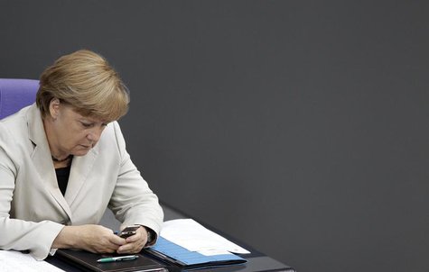 German Chancellor Angela Merkel looks at her mobile phone during a session of the Bundestag, German lower house of parliament, at the Reichs German Chancellor Angela Merkel looks at her mobile phone during a session of the Bundestag, German lower house of parliament, at the Reichs