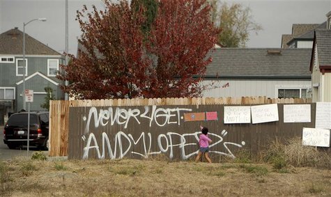 A girl reads signs in a vacant lot where 13-year-old Andy Lopez Cruz was shot and killed by sheriff's deputies on Tuesday in Santa Rosa, Cal A girl reads signs in a vacant lot where 13-year-old Andy Lopez Cruz was shot and killed by sheriff's deputies on Tuesday in Santa Rosa, Cal