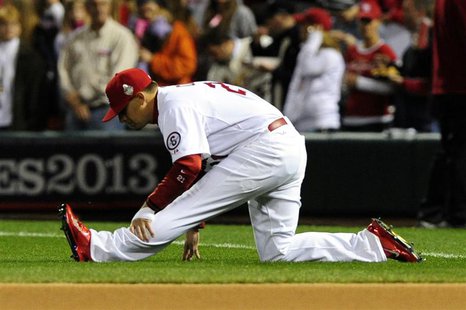 St. Louis Cardinals first baseman Allen Craig (21) stretches prior to starting at first base for game five of the MLB baseball World Series St. Louis Cardinals first baseman Allen Craig (21) stretches prior to starting at first base for game five of the MLB baseball World Series