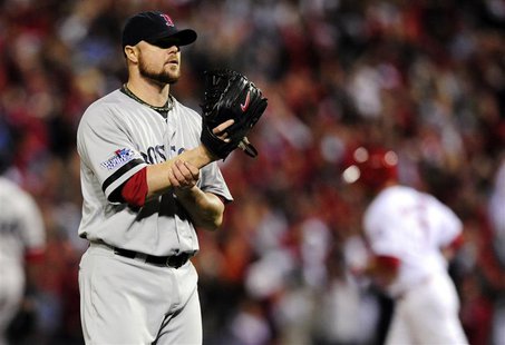 Oct 28, 2013; St. Louis, MO, USA; Boston Red Sox starting pitcher Jon Lester (left) reacts after giving up a home run to St. Louis Cardinals Oct 28, 2013; St. Louis, MO, USA; Boston Red Sox starting pitcher Jon Lester (left) reacts after giving up a home run to St. Louis Cardinals
