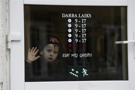 A boy looks through a shop window in Valka October 25, 2013. REUTERS/Ints Kalnins A boy looks through a shop window in Valka October 25, 2013. REUTERS/Ints Kalnins