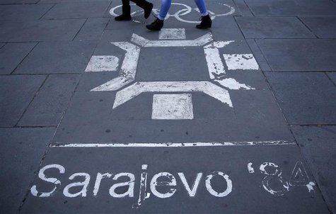 People walk past the logo of the Winter Olympics in Sarajevo, painted on the streets in central Sarajevo October 27, 2013. REUTERS/Dado Ruvi People walk past the logo of the Winter Olympics in Sarajevo, painted on the streets in central Sarajevo October 27, 2013. REUTERS/Dado Ruvi