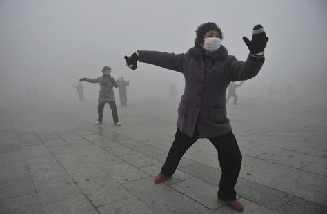 A woman wears a mask as she does her morning exercise outdoors in Fuyang, Anhui province, January 14, 2013. REUTERS/China Daily A woman wears a mask as she does her morning exercise outdoors in Fuyang, Anhui province, January 14, 2013. REUTERS/China Daily