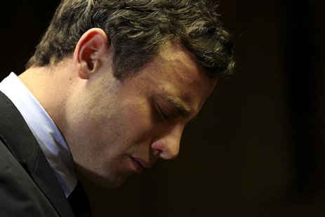 Olympic and Paralympic running star Oscar Pistorius reacts ahead of court proceedings at the Pretoria Magistrates court, August 19, 2013. RE Olympic and Paralympic running star Oscar Pistorius reacts ahead of court proceedings at the Pretoria Magistrates court, August 19, 2013. RE