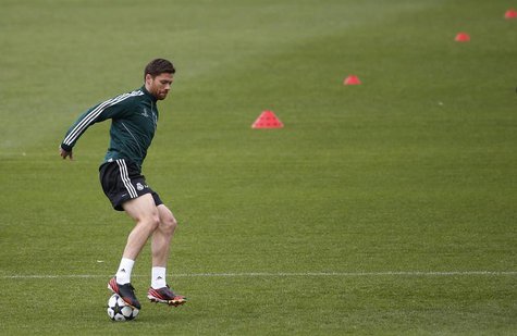 Real Madrid's Xabi Alonso controls the ball during a training session on the eve of their Champions League semi-final second leg soccer matc Real Madrid's Xabi Alonso controls the ball during a training session on the eve of their Champions League semi-final second leg soccer matc