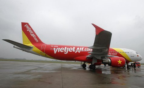 A VietJet A320 airplane is seen while parking before departure for Bangkok, at Noi Bai international airport in Hanoi September 25, 2013. RE A VietJet A320 airplane is seen while parking before departure for Bangkok, at Noi Bai international airport in Hanoi September 25, 2013. RE
