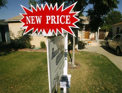 A real estate sign, which indicates the 'new price', stands outside a three-bedroom and one-bath home in Burbank, California October 9, 2007 A real estate sign, which indicates the 'new price', stands outside a three-bedroom and one-bath home in Burbank, California October 9, 2007