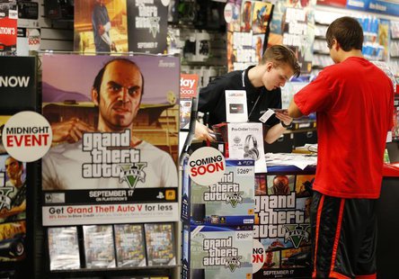 Game enthusiasts purchase the latest release of "Grand Theft Auto Five" after the game went on sale at the Game Stop store in Encinitas, Cal Game enthusiasts purchase the latest release of "Grand Theft Auto Five" after the game went on sale at the Game Stop store in Encinitas, Cal