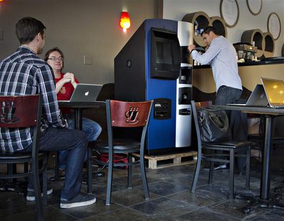 Vancouver Bitcoiniacs Trading Company co-founder Mitchell Demeter prepares, according to him, the first bitcoin ATM machine in a Waves Coffe Vancouver Bitcoiniacs Trading Company co-founder Mitchell Demeter prepares, according to him, the first bitcoin ATM machine in a Waves Coffe
