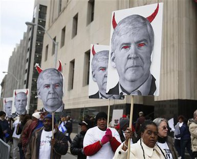 Protesters hold posters depicting Michigan Governor Rick Snyder as a devil, at a rally outside Theodore Levin U.S. Courthouse during Detroit's bankruptcy eligibility trial in Detroit, Michigan October 28, 2013.
REUTERS/Rebecca Cook Protesters hold posters depicting Michigan Governor Rick Snyder as a devil, at a rally outside Theodore Levin U.S. Courthouse during Detroit's bankruptcy eligibility trial in Detroit, Michigan October 28, 2013.
REUTERS/Rebecca Cook