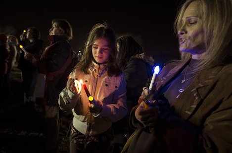 Residents of Staten Island in New York City hold lights and candles as they stand on Midland Beach on the south shore of the Island during a Residents of Staten Island in New York City hold lights and candles as they stand on Midland Beach on the south shore of the Island during a