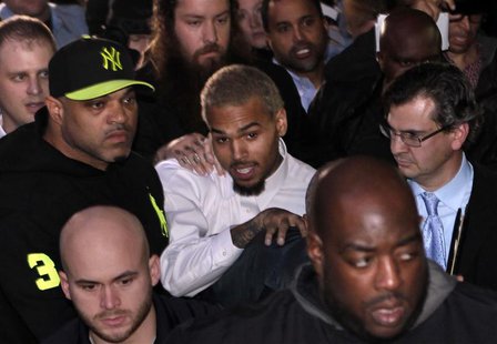 Rapper Chris Brown (C) leaves the U.S. District Court in Washington October 28, 2013. Rapper Chris Brown was due in court to face a felony a Rapper Chris Brown (C) leaves the U.S. District Court in Washington October 28, 2013. Rapper Chris Brown was due in court to face a felony a