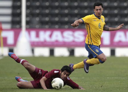 Sweden's Jiloan Hamad (R) fights for the ball with Qatar Olympic team's Mohammed AlJabri during their international friendly match in Doha J Sweden's Jiloan Hamad (R) fights for the ball with Qatar Olympic team's Mohammed AlJabri during their international friendly match in Doha J