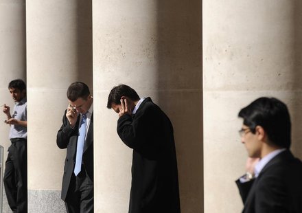 City workers make phone calls outside the London Stock Exchange in Paternoster Square in the City of London at lunchtime October 1, 2008. RE City workers make phone calls outside the London Stock Exchange in Paternoster Square in the City of London at lunchtime October 1, 2008. RE
