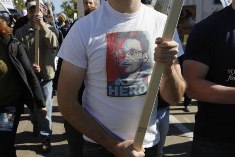 A demonstrator wears a T-shirt depicting former U.S. spy agency contractor Edward Snowden at the "Stop Watching Us: A Rally Against Mass Sur A demonstrator wears a T-shirt depicting former U.S. spy agency contractor Edward Snowden at the "Stop Watching Us: A Rally Against Mass Sur