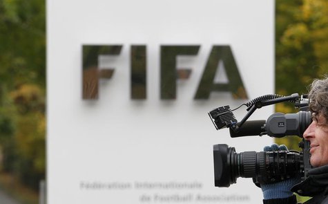 A cameraman films in front of the main entrance of the Home of FIFA in Zurich October 19, 2010. REUTERS/Christian Hartmann A cameraman films in front of the main entrance of the Home of FIFA in Zurich October 19, 2010. REUTERS/Christian Hartmann