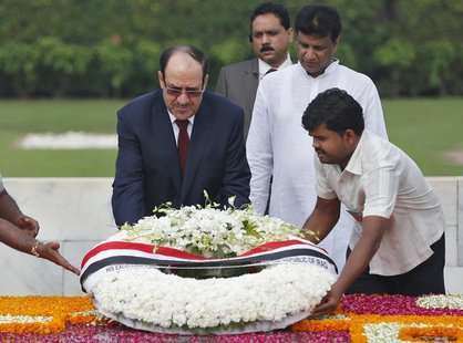 Iraqi Prime Minister Nuri al-Maliki (L) places a wreath at the Mahatma Gandhi memorial at Rajghat in New Delhi August 23, 2013. REUTERS/Ahma Iraqi Prime Minister Nuri al-Maliki (L) places a wreath at the Mahatma Gandhi memorial at Rajghat in New Delhi August 23, 2013. REUTERS/Ahma