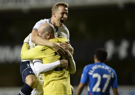 Tottenham Hotspur's Harry Kane (top) celebrates beating Hull City in a penalty shoot out with Kyle Walker and Brad Friedel (front L) during Tottenham Hotspur's Harry Kane (top) celebrates beating Hull City in a penalty shoot out with Kyle Walker and Brad Friedel (front L) during