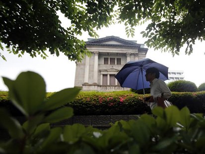 A pedestrian holding an umbrella walks past the Bank of Japan building in Tokyo June 11, 2013. REUTERS/Yuya Shino A pedestrian holding an umbrella walks past the Bank of Japan building in Tokyo June 11, 2013. REUTERS/Yuya Shino