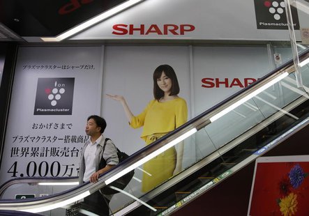 A man rides an escalator past Sharp Corp's advertisements at an electronics retail store in Tokyo October 31, 2013. REUTERS/Toru Hanai A man rides an escalator past Sharp Corp's advertisements at an electronics retail store in Tokyo October 31, 2013. REUTERS/Toru Hanai
