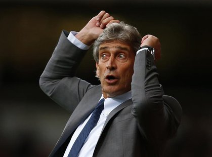 Manchester City's manager Manuel Pellegrini reacts during their English Premier League soccer match against West Ham United at the Boleyn Gr Manchester City's manager Manuel Pellegrini reacts during their English Premier League soccer match against West Ham United at the Boleyn Gr