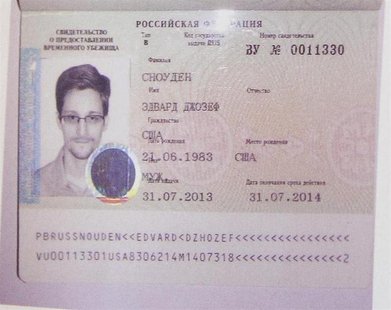 Fugitive former U.S. spy agency contractor Edward Snowden's new refugee documents granted by Russia is seen during a news conference in Mosc Fugitive former U.S. spy agency contractor Edward Snowden's new refugee documents granted by Russia is seen during a news conference in Mosc