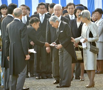 Japanese lawmaker Taro Yamamoto (3rd L) hands a letter to Emperor Akihito (front C), while Empress Michiko (R) looks on, during the annual a Japanese lawmaker Taro Yamamoto (3rd L) hands a letter to Emperor Akihito (front C), while Empress Michiko (R) looks on, during the annual a